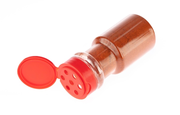 bottle paprika powder isolated on white background.