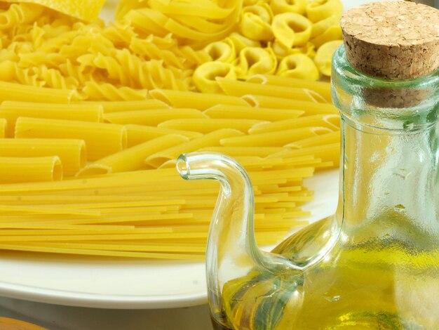 A bottle of pasta with a cork in it