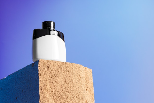 Bottle of perfume on cinder block close up