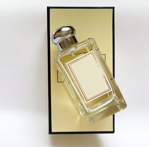 a bottle of perfume from a yellow box on a white isolated background
