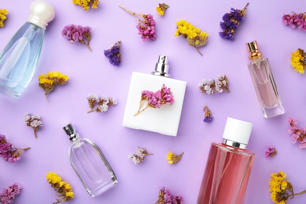 Bottle of perfume with flowers. Top view