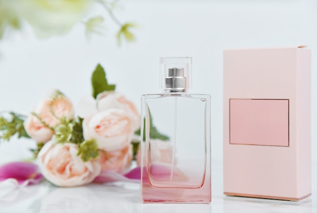 Bottle of perfume with fresh flowers