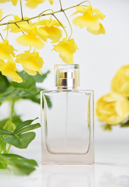 Bottle of perfume with fresh flowers