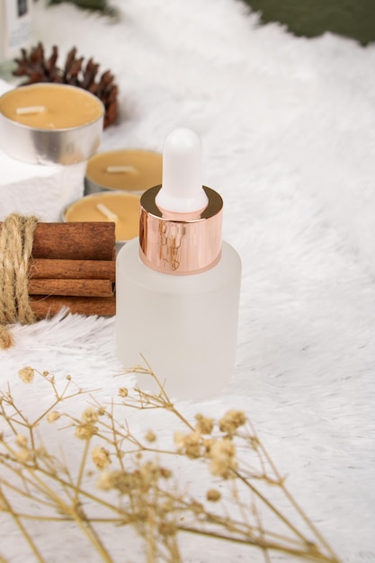 a bottle of perfume with a gold candle in the middle