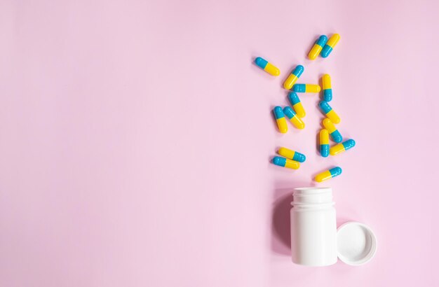 A bottle of pills and a bottle of pills on a pink background