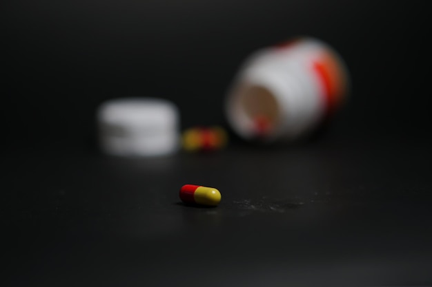 a bottle of pills that is white and red