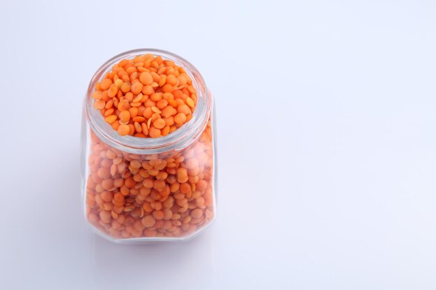 Bottle of red lentils on the white background