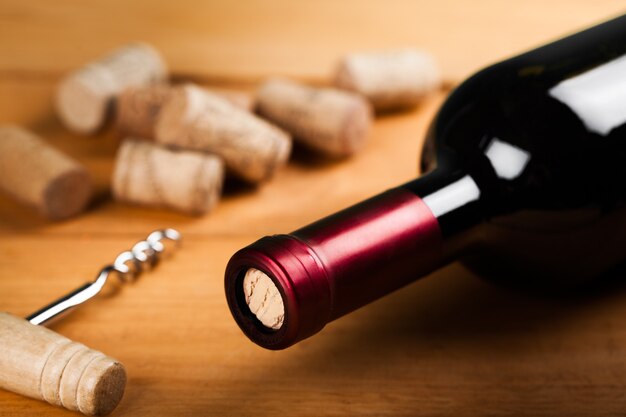 Bottle of red wine and corks, close-up view