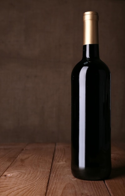 Bottle of red wine on dark background