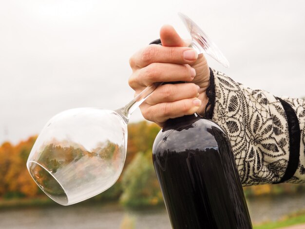 Bottle of red wine in female hands