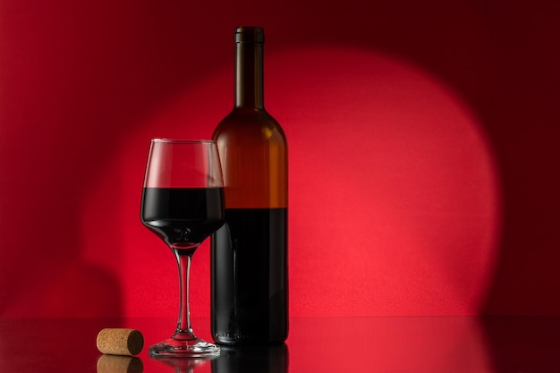 Bottle of red wine with wine glass and cork on table View with space for your text