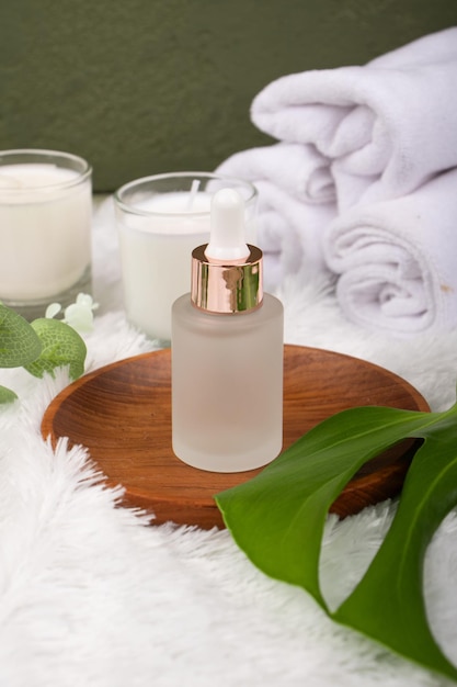 a bottle of serum sits on a table with a plant in the background