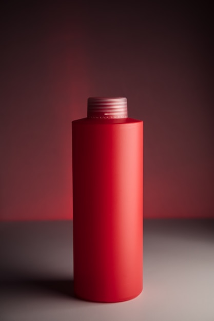 Bottle for shampoo on a red background