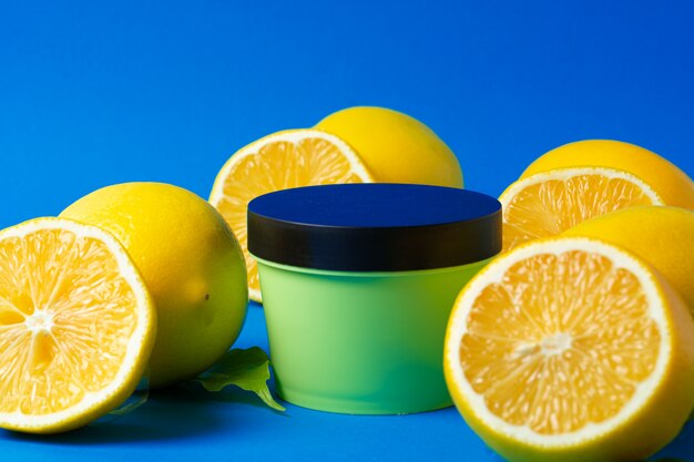 Bottle of skincare cosmetics with sliced lemons