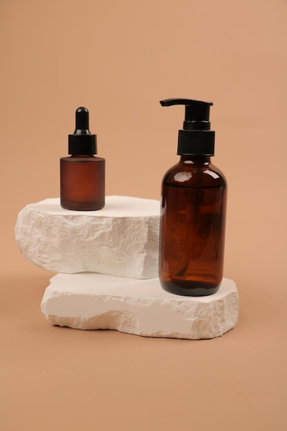 a bottle of soap sits next to a stone with a bottle of hand soap on it