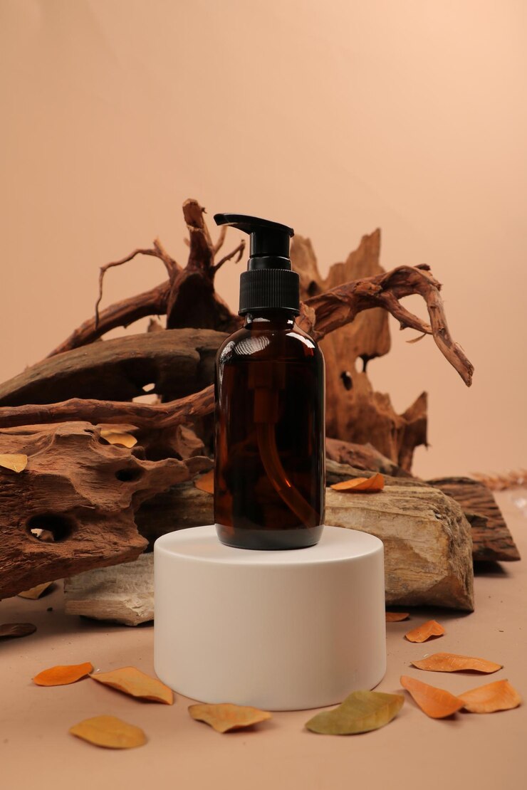 a bottle of soap sits on a table with a piece of wood in the background