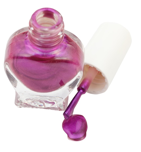 Bottle and spilled violet nail polish isolated