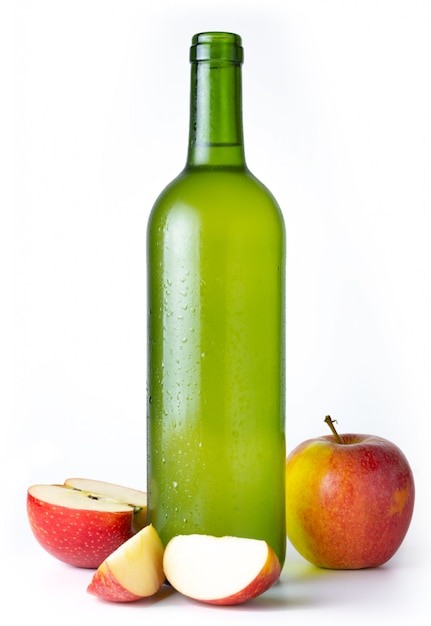 Bottle of very cold cider with apples with white 