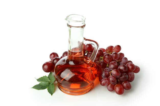 Bottle of vinegar and grape isolated on white background