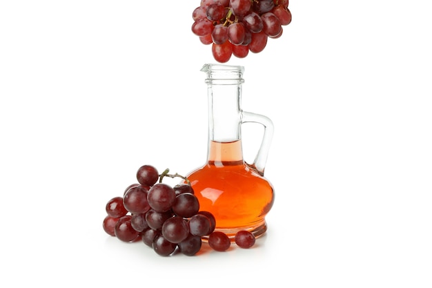 Bottle of vinegar and grape isolated on white background