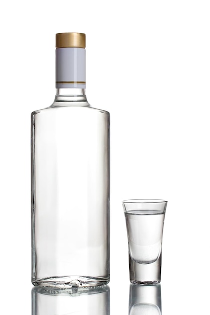 Bottle of vodka and wineglass isolated on white