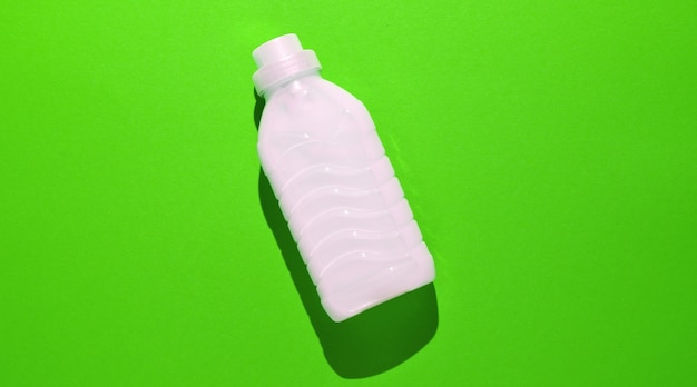 bottle of washing gel on green.