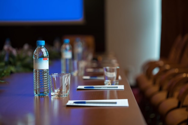 Bottle water on desk in conference hall xA