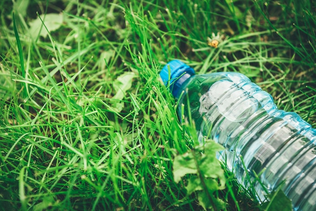 Bottle of water on grass background