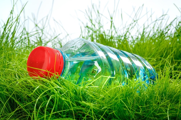 Bottle of water on the green grass