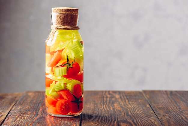 Bottle of Water Infused with Cherry Tomato and Celery Stems