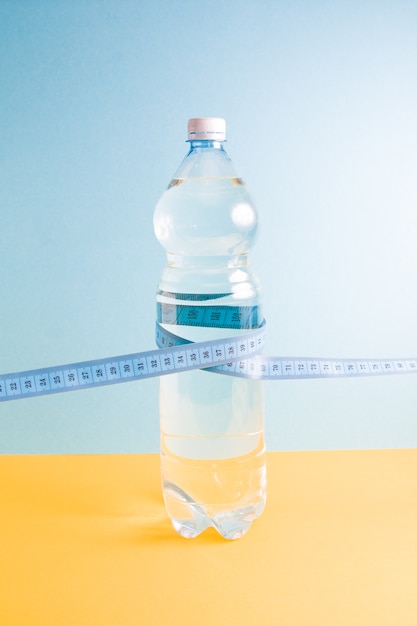 A bottle of water and measuring tape 