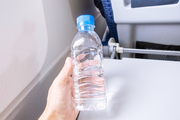 Premium Photo  A bottle of water for passenger on the aircraft