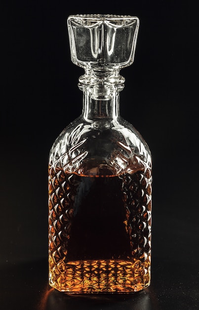 Photo bottle of whiskey, or rum, or alcohol stands