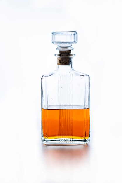 Bottle of whiskey on white background