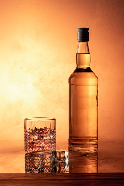 Foto bottiglia di whisky con sfondo di fumo arancione brillante