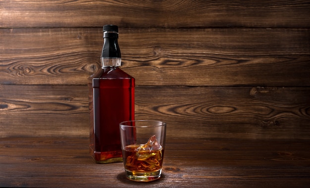 Bottle of whiskey on a wooden background