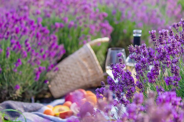 A bottle of wine on a background of a lavender field Glasses with wine fruits