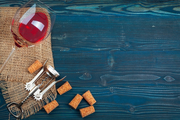 Bottle of wine and cork and corkscrew on wooden table