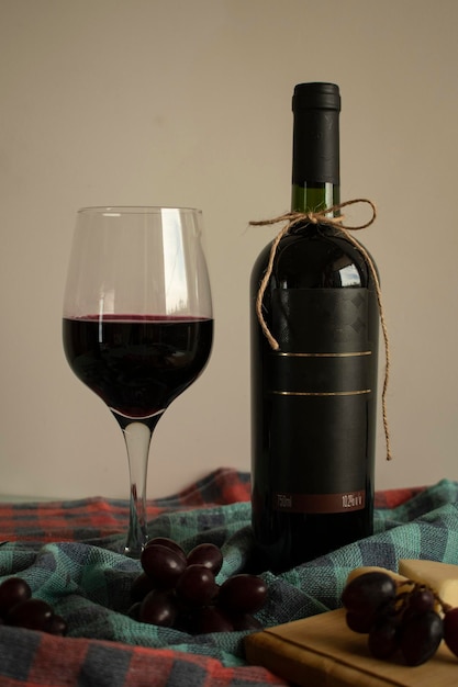 a bottle of wine next to a glass with a bottle of wine
