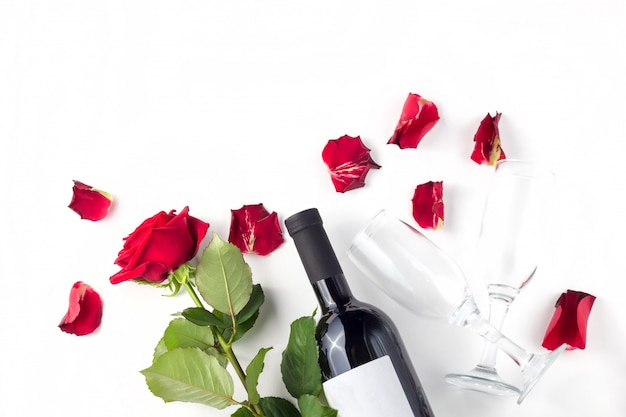 Bottle of wine, glasses and red roses