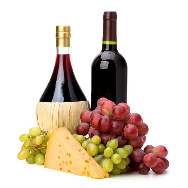 a bottle of wine and grapes are next to a bottle of wine