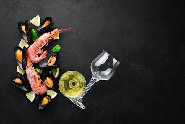 A bottle of wine and seafood Top view Free space for your text On the old background