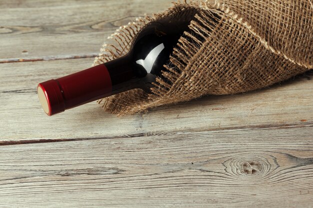 Bottle of wine over wooden table