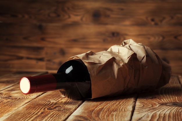 Bottle of wine over wooden wall