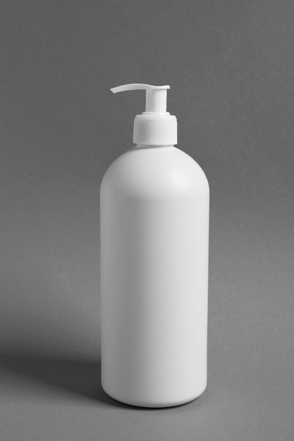 Photo bottle with cosmetic product on grey background