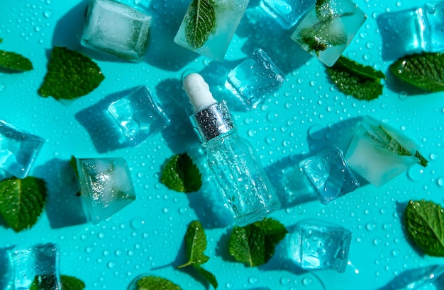 Bottle with cosmetics on a mint background with ice cubes and lemon Selective focus