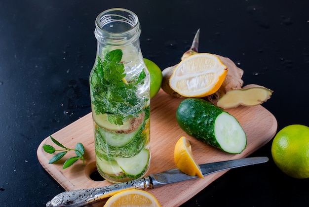 Bottle with detox fresh organic cucumber, lemon and mint water 