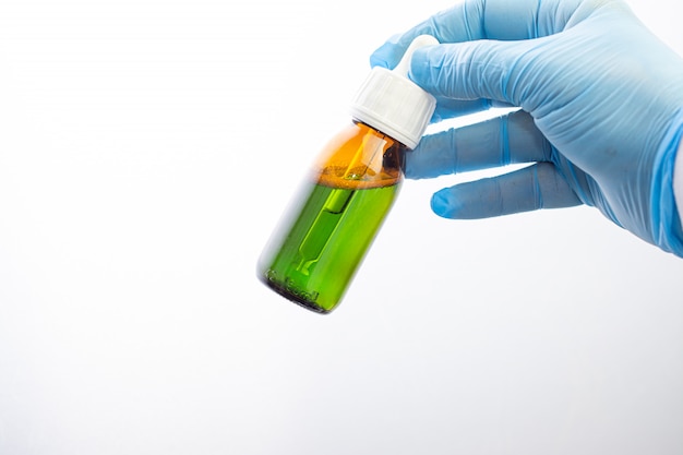 Bottle with dropper in the hands of a doctor in the laboratory.