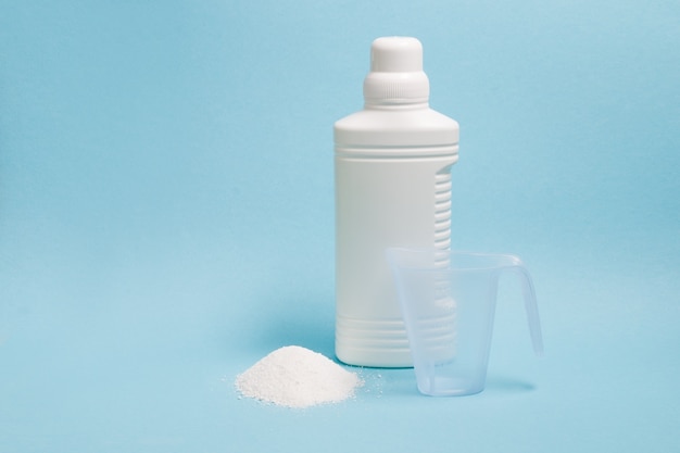 Bottle with liquid gel for washing without labels and a measuring cup with washing powder