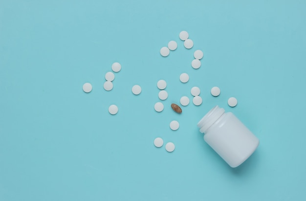 Bottle with pills on a blue background